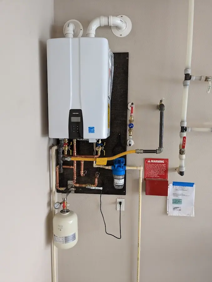 Professional plumber installing copper piping in a Bridgeport home